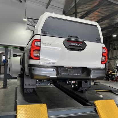 Toyota Hilux with canopy on the wheel alignment ramp
