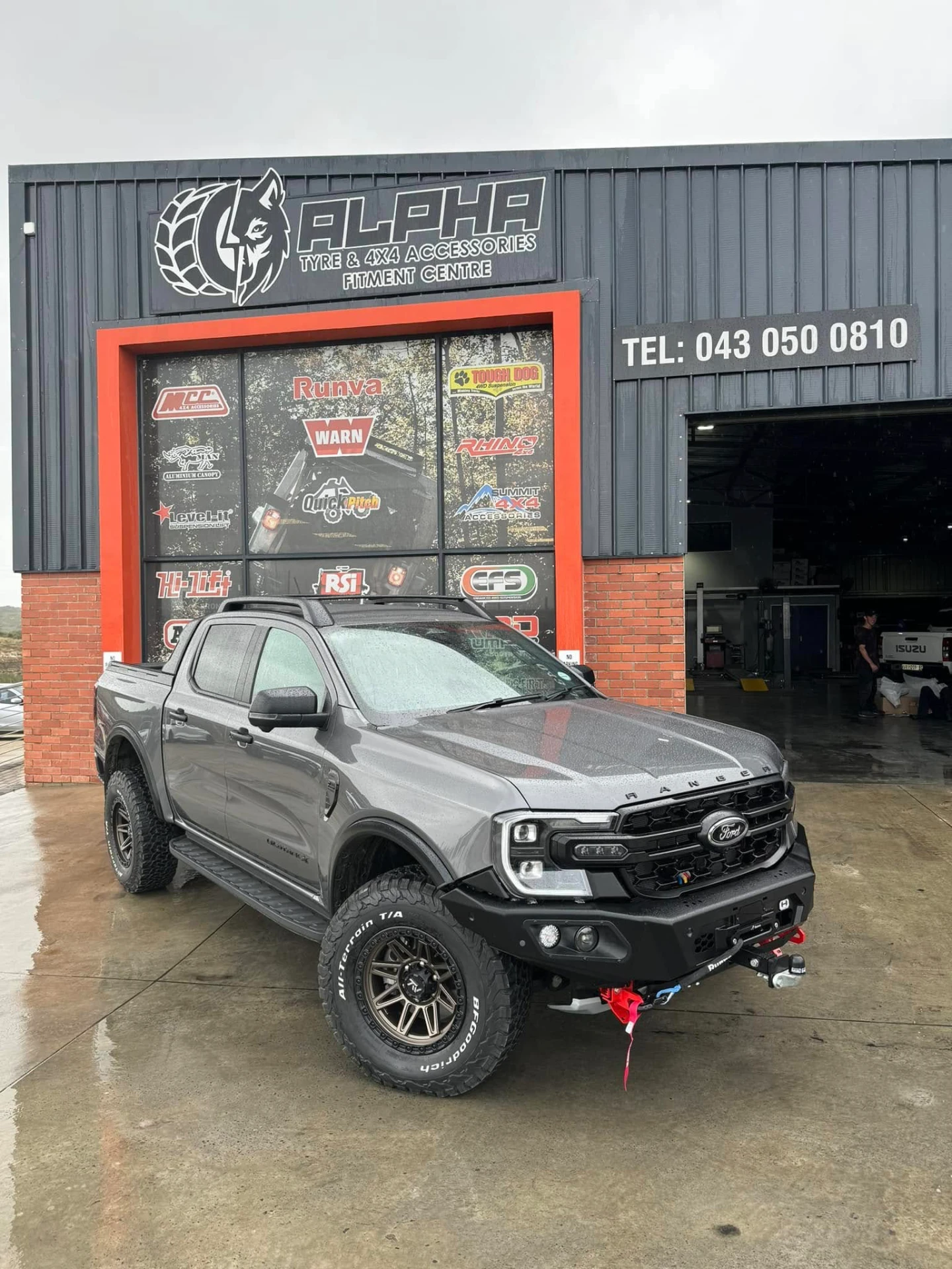 Ford Ranger double-cab fitted with a heavy-duty steel bull bar, winch, recovery shackles, suspension lift, side steps and BFGoodrich all-terrain tyres outside the Alpha Tyre & 4x4 fitment centre in East London