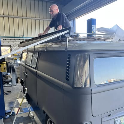 VW Kombi fitted with a roof rack and side awning at Alpha