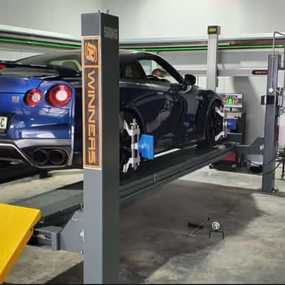 Nissan GT-R up on the four-post lift in the workshop