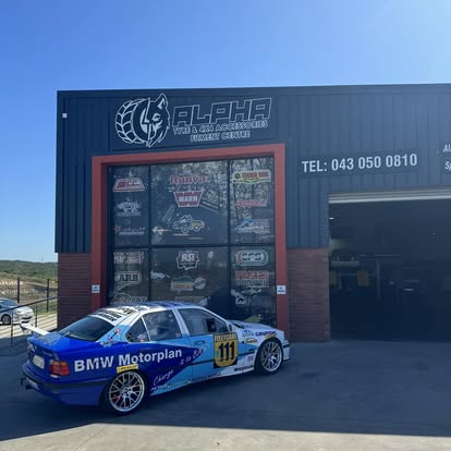 BMW Motorplan E36 race car outside the workshop