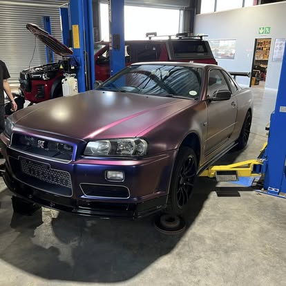Colour-shift wrapped Nissan Skyline R34 in the workshop bay